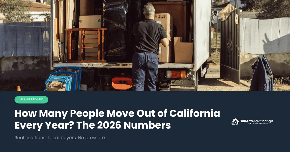 Man in his driveway packing a moving truck outside of his home in California.