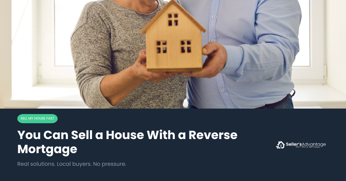 Elder couple in their Southern California home, holding up a mini model house.